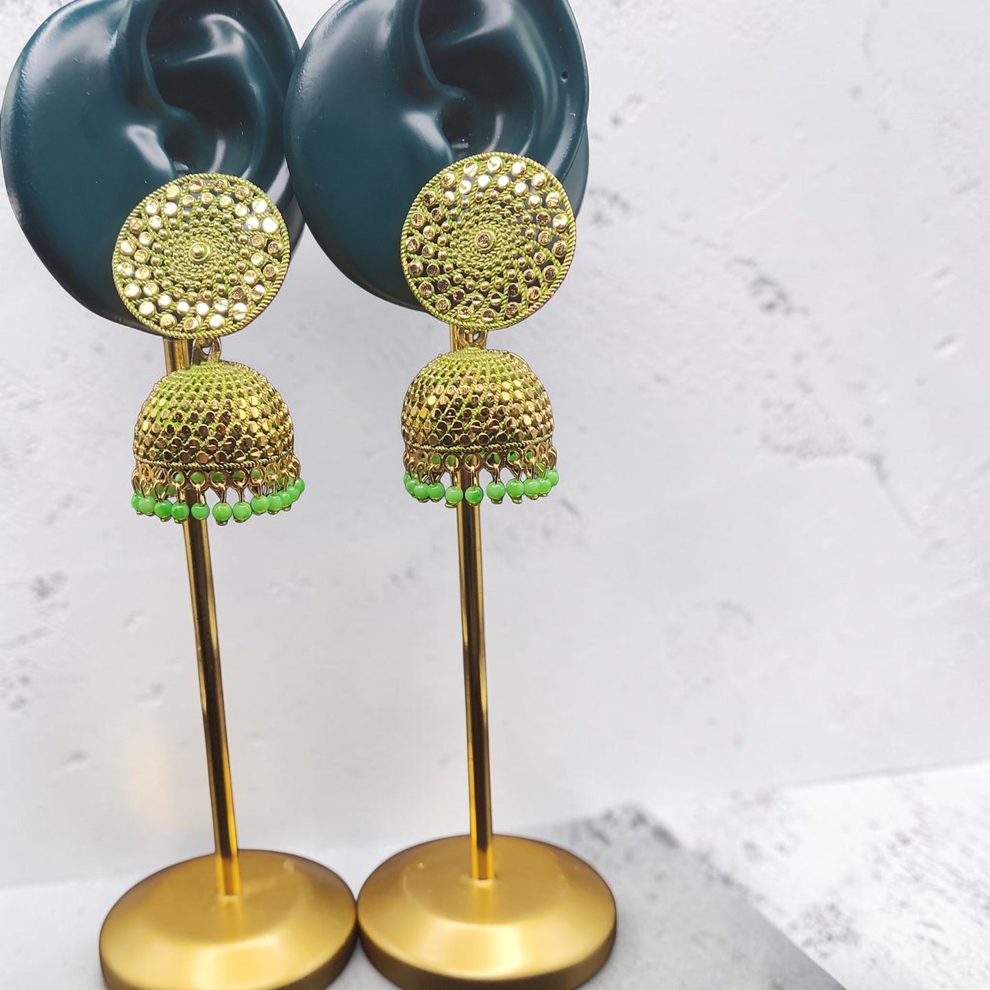 PSK ELEGANCE Gold Jhumka Earrings with Green Bead Detailing