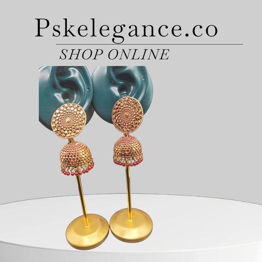 PSK ELEGANCE Gold Jhumka Earrings with Red Bead Detailing