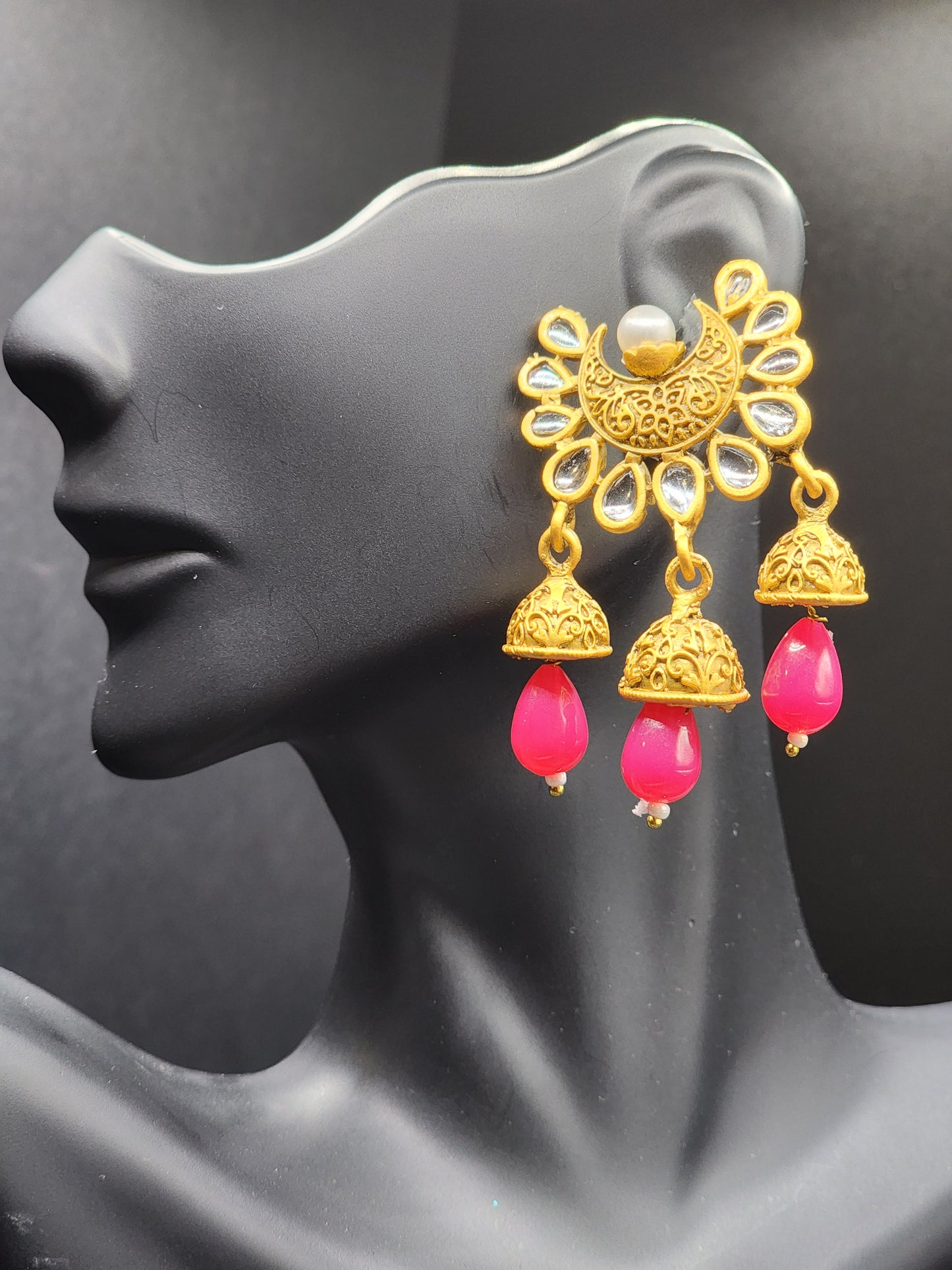 Bold, vibrant, and made to stand out. It's got rich enamel, intricate gold-tone work, and layered bead drops, this piece is desi