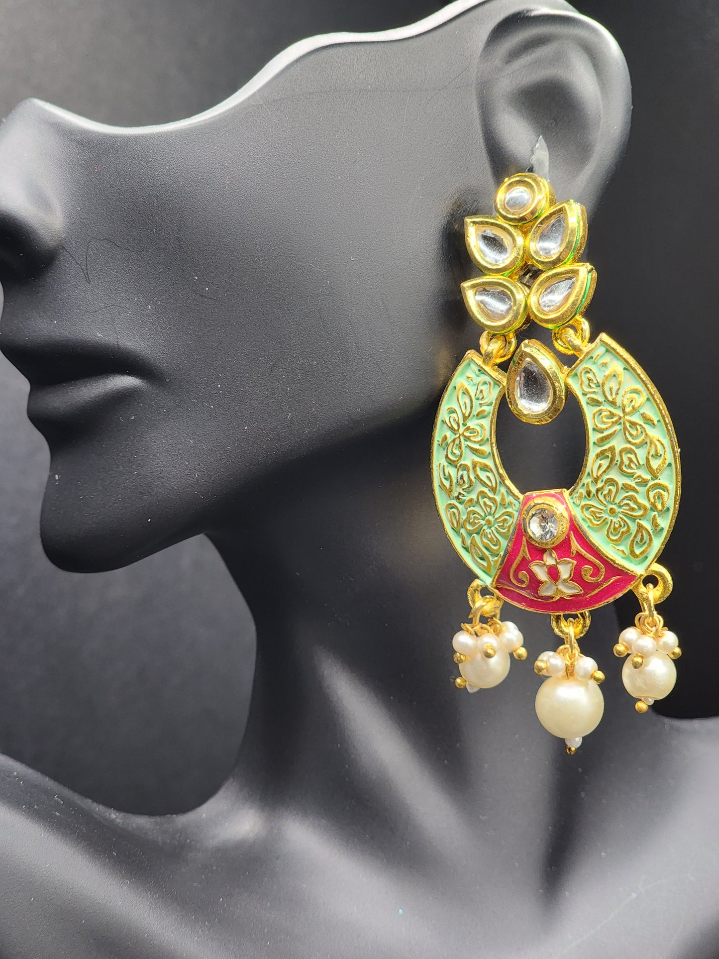 Bold, vibrant, and made to stand out. It's got rich enamel, intricate gold-tone work, and layered bead drops, this piece is desi