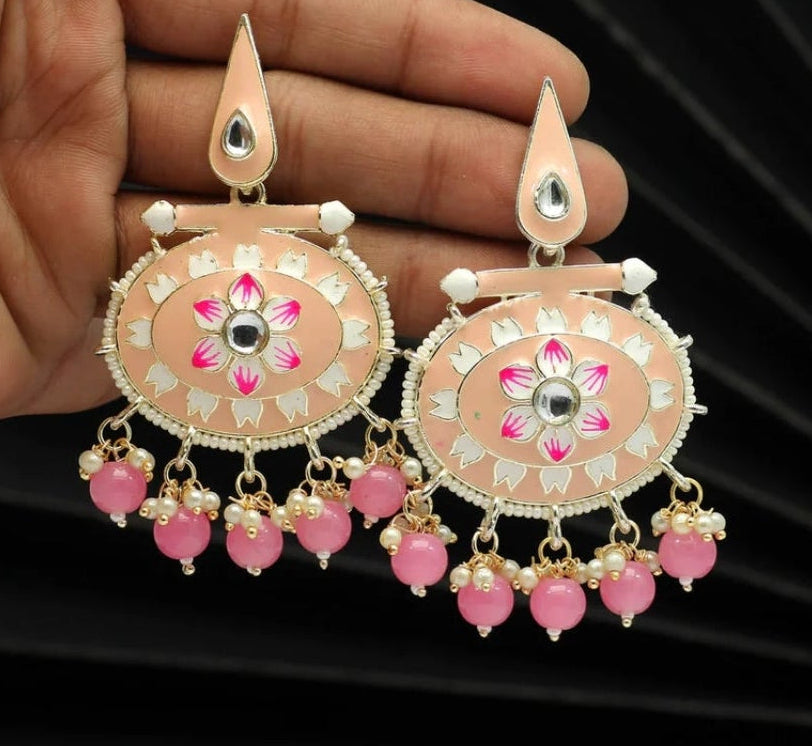 Bold, vibrant, and made to stand out. It's got rich enamel, intricate gold-tone work, and layered bead drops, this piece is desi