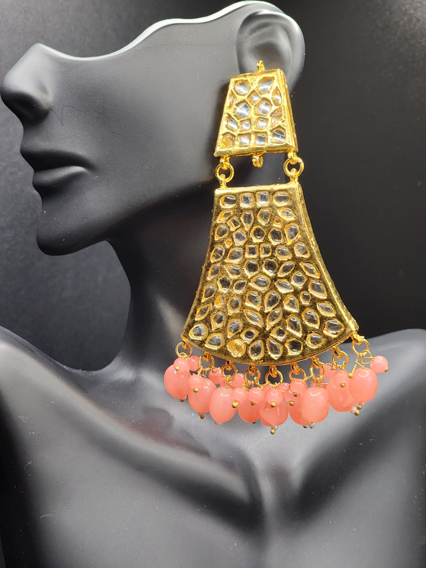 Bold, vibrant, and made to stand out. It's got rich enamel, intricate gold-tone work, and layered bead drops, this piece is desi
