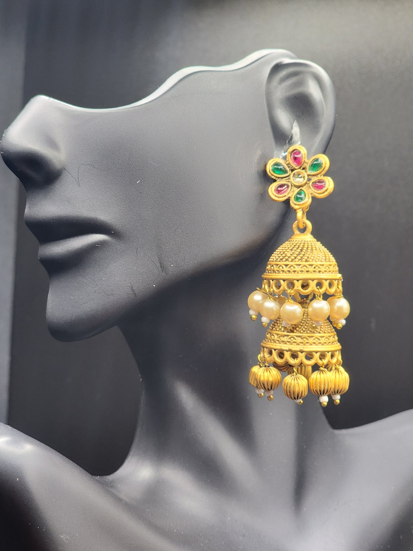 Bold, vibrant, and made to stand out. It's got rich enamel, intricate gold-tone work, and layered bead drops, this piece is desi