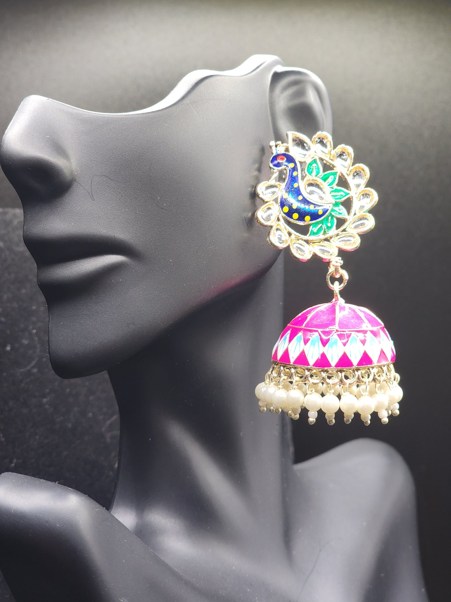 Bold, vibrant, and made to stand out. It's got rich enamel, intricate gold-tone work, and layered bead drops, this piece is desi