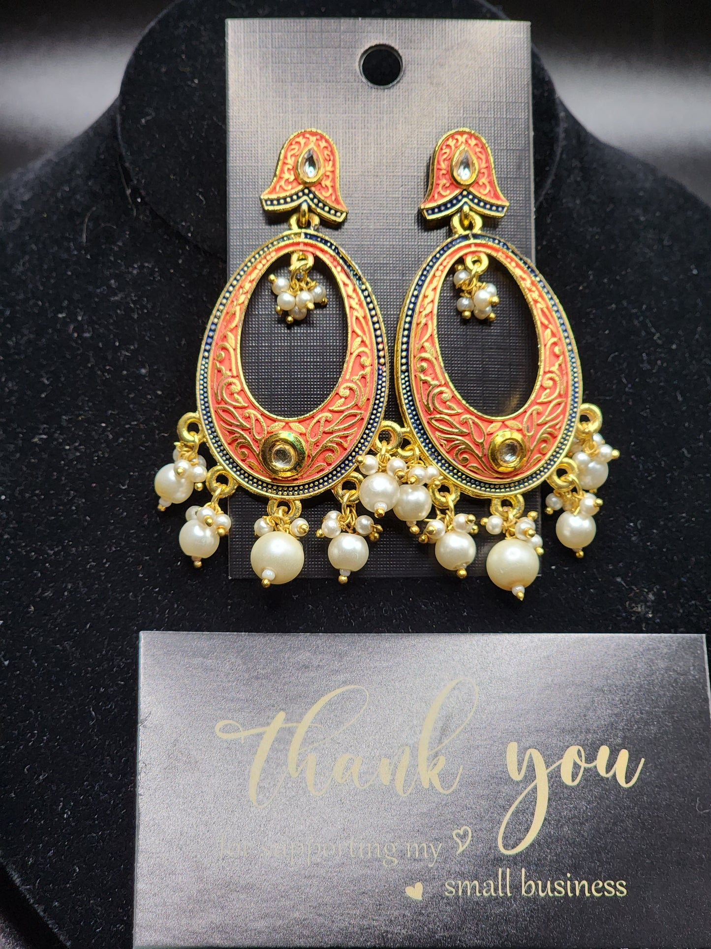 Bold, vibrant, and made to stand out. It's got rich enamel, intricate gold-tone work, and layered bead drops, this piece is desi