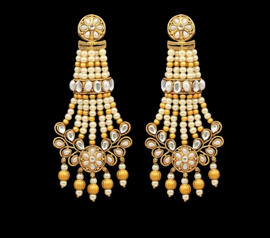 Bold, vibrant, and made to stand out. It's got rich enamel, intricate gold-tone work, and layered bead drops, this piece is desi