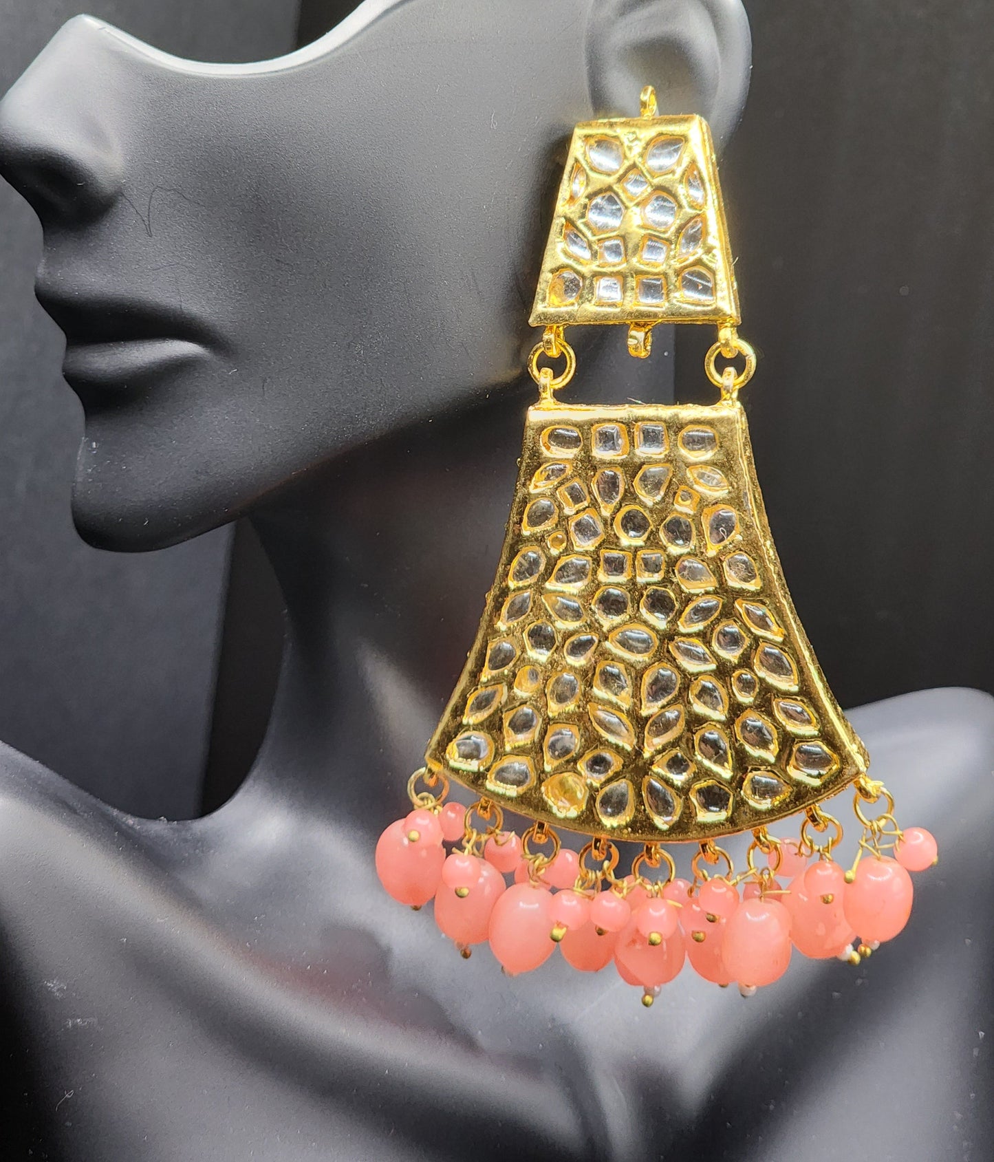Bold, vibrant, and made to stand out. It's got rich enamel, intricate gold-tone work, and layered bead drops, this piece is desi