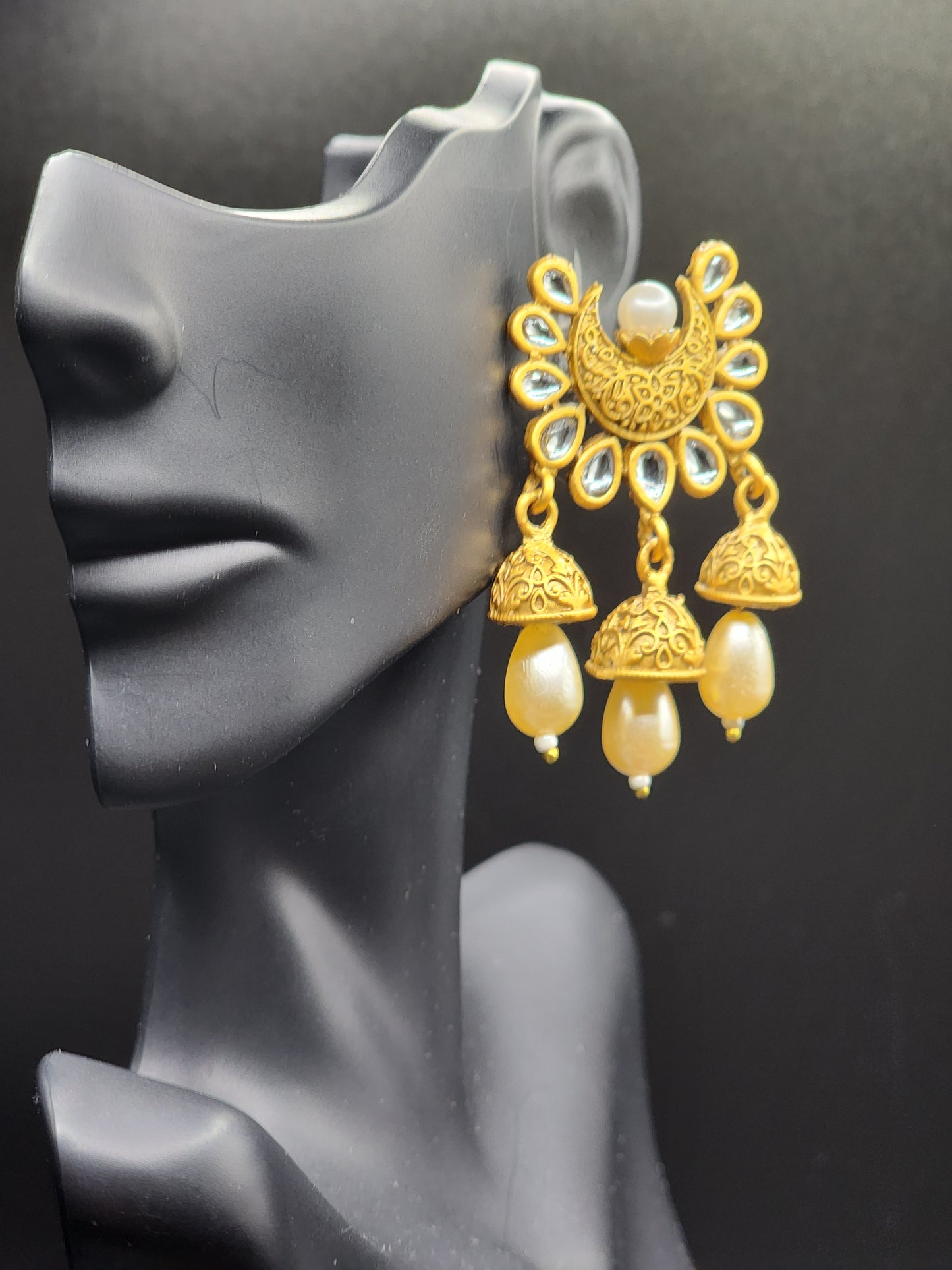 Bold, vibrant, and made to stand out. It's got rich enamel, intricate gold-tone work, and layered bead drops, this piece is desi