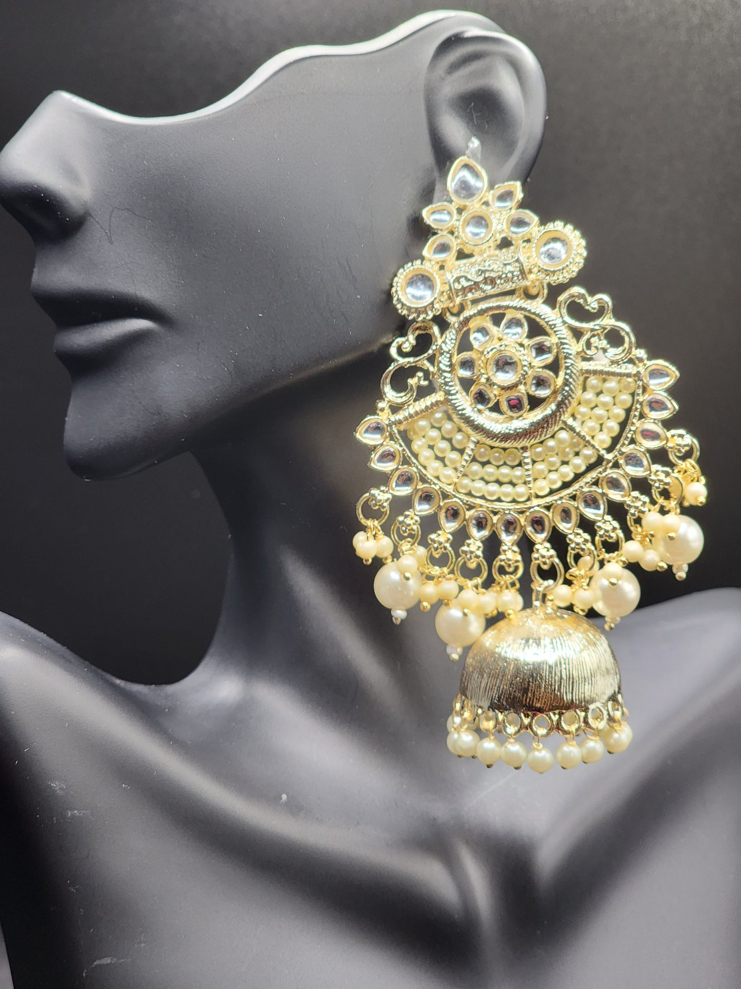 Bold, vibrant, and made to stand out. It's got rich enamel, intricate gold-tone work, and layered bead drops, this piece is desi