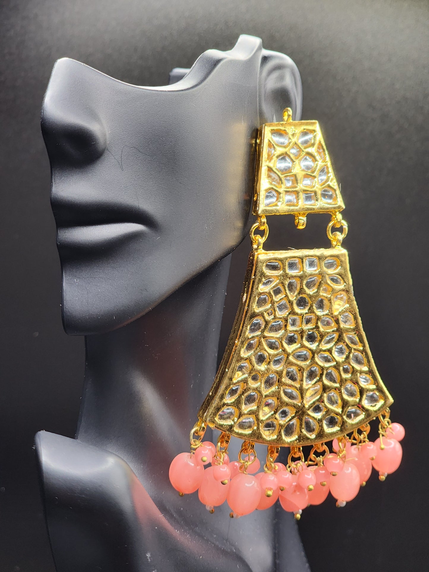 Bold, vibrant, and made to stand out. It's got rich enamel, intricate gold-tone work, and layered bead drops, this piece is desi