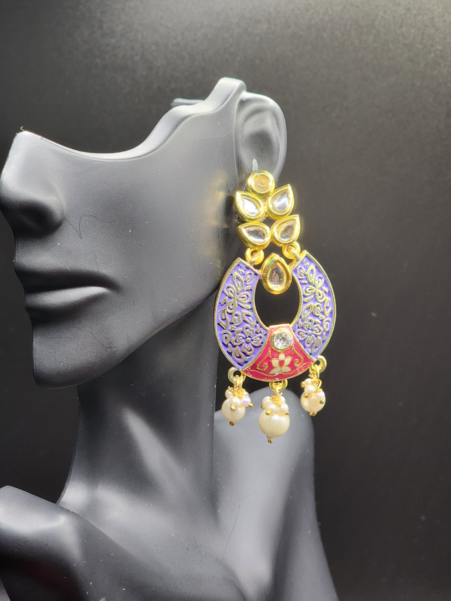Bold, vibrant, and made to stand out. It's got rich enamel, intricate gold-tone work, and layered bead drops, this piece is desi