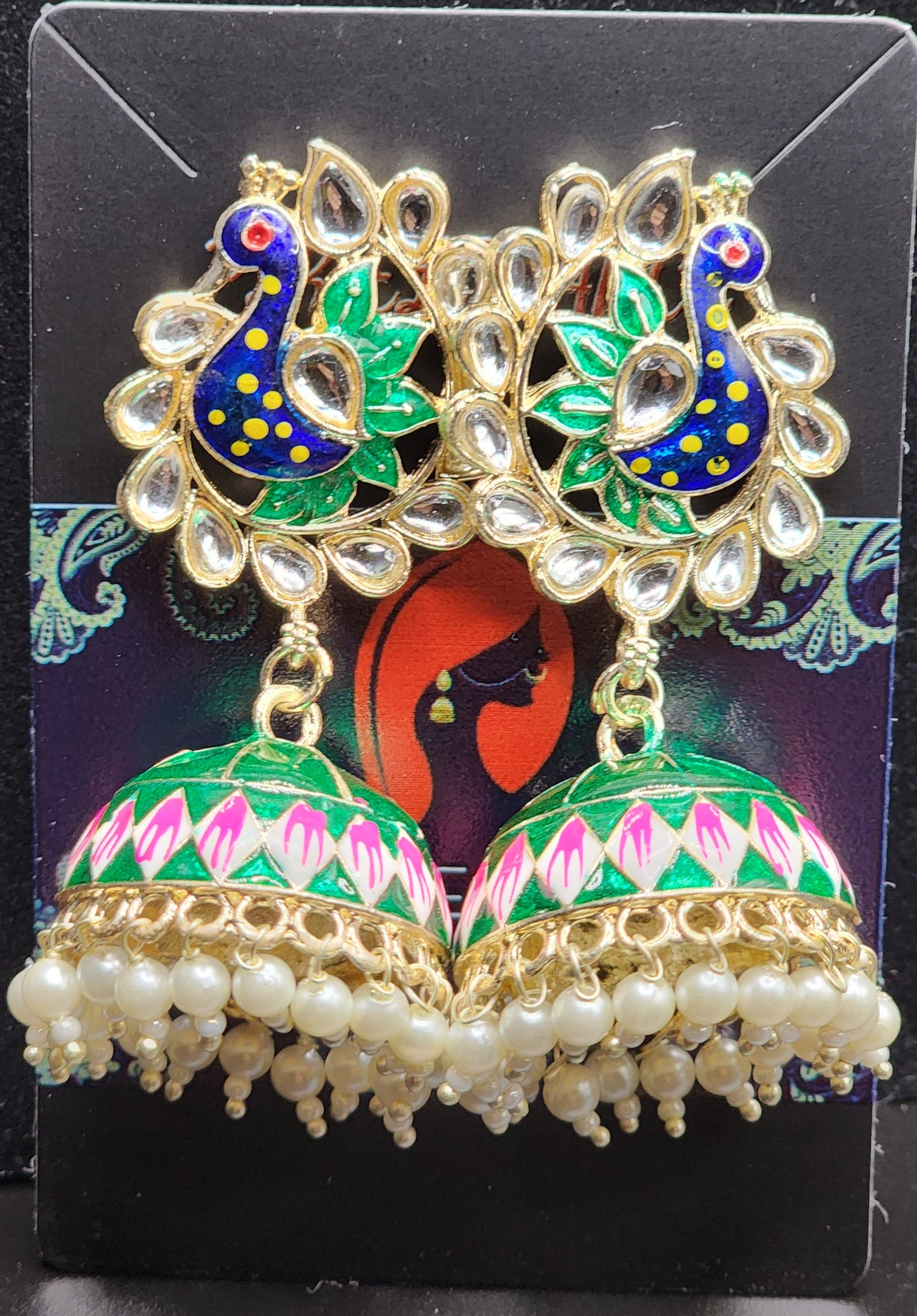 Bold, vibrant, and made to stand out. It's got rich enamel, intricate gold-tone work, and layered bead drops, this piece is desi