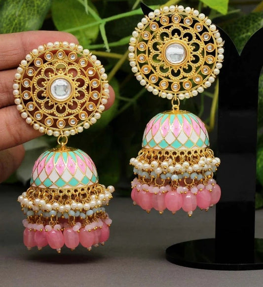 Bold, vibrant, and made to stand out. It's got rich enamel, intricate gold-tone work, and layered bead drops, this piece is desi