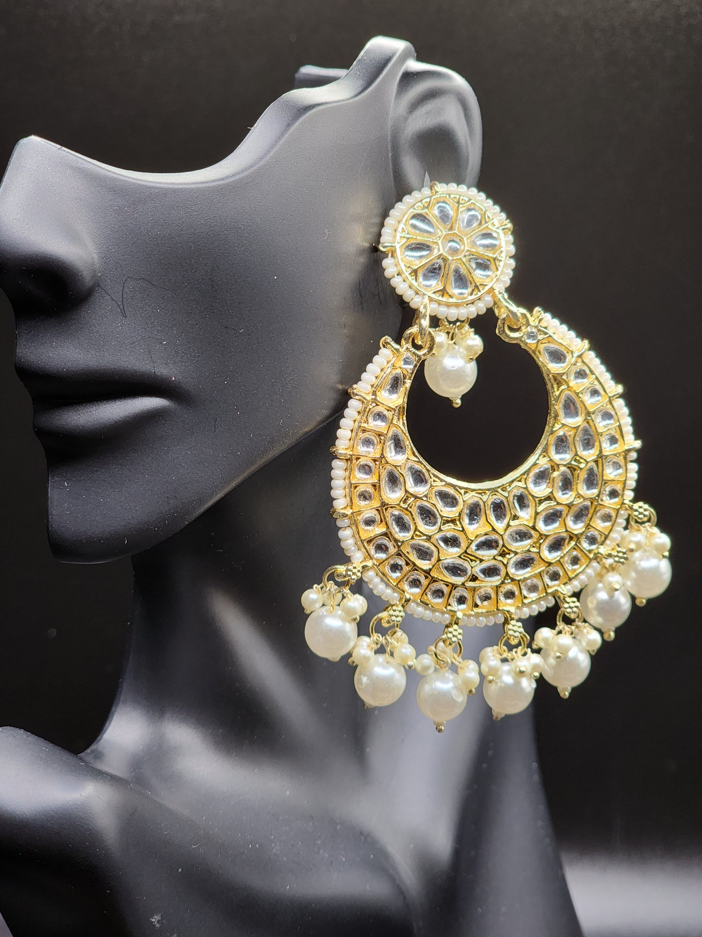 Bold, vibrant, and made to stand out. It's got rich enamel, intricate gold-tone work, and layered bead drops, this piece is desi