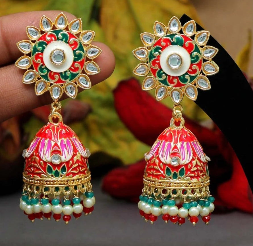 Bold, vibrant, and made to stand out. It's got rich enamel, intricate gold-tone work, and layered bead drops, this piece is desi