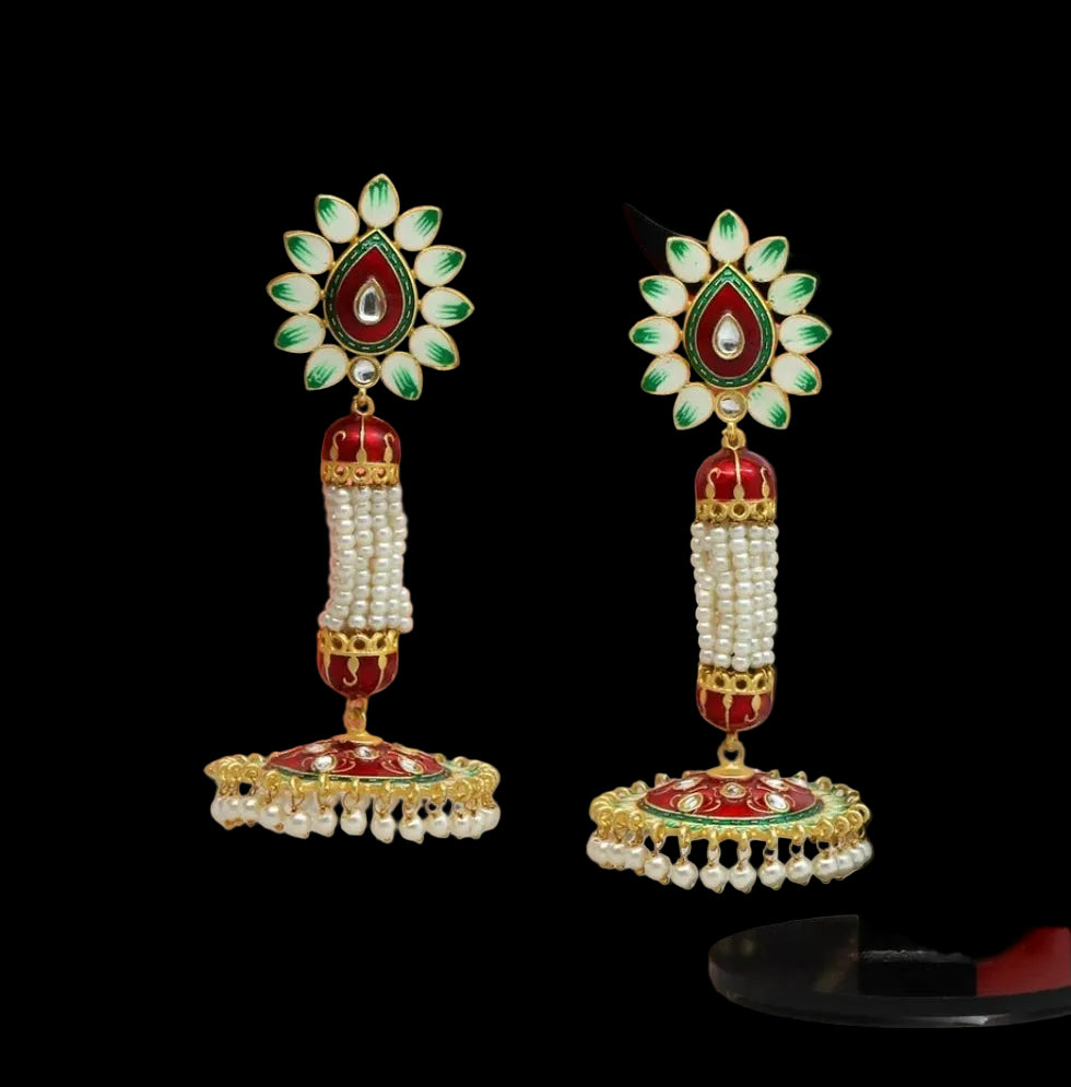 Bold, vibrant, and made to stand out. It's got rich enamel, intricate gold-tone work, and layered bead drops, this piece is desi