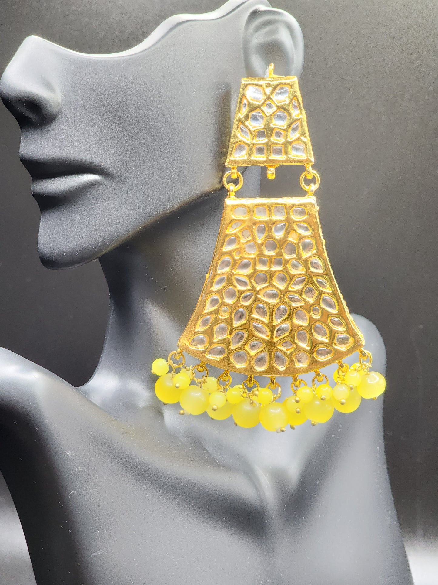 Bold, vibrant, and made to stand out. It's got rich enamel, intricate gold-tone work, and layered bead drops, this piece is desi