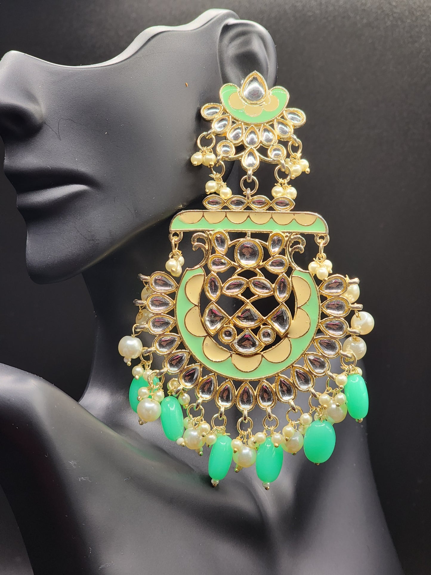 Bold, vibrant, and made to stand out. It's got rich enamel, intricate gold-tone work, and layered bead drops, this piece is desi
