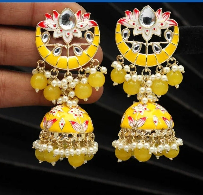 Bold, vibrant, and made to stand out. It's got rich enamel, intricate gold-tone work, and layered bead drops, this piece is desi
