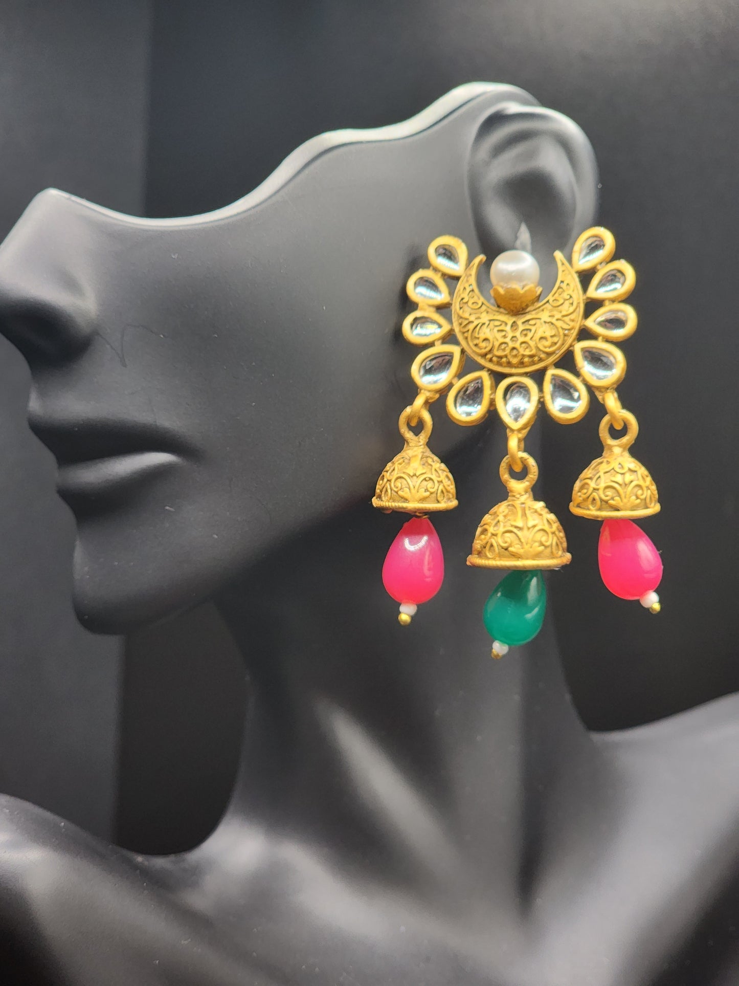 Bold, vibrant, and made to stand out. It's got rich enamel, intricate gold-tone work, and layered bead drops, this piece is desi