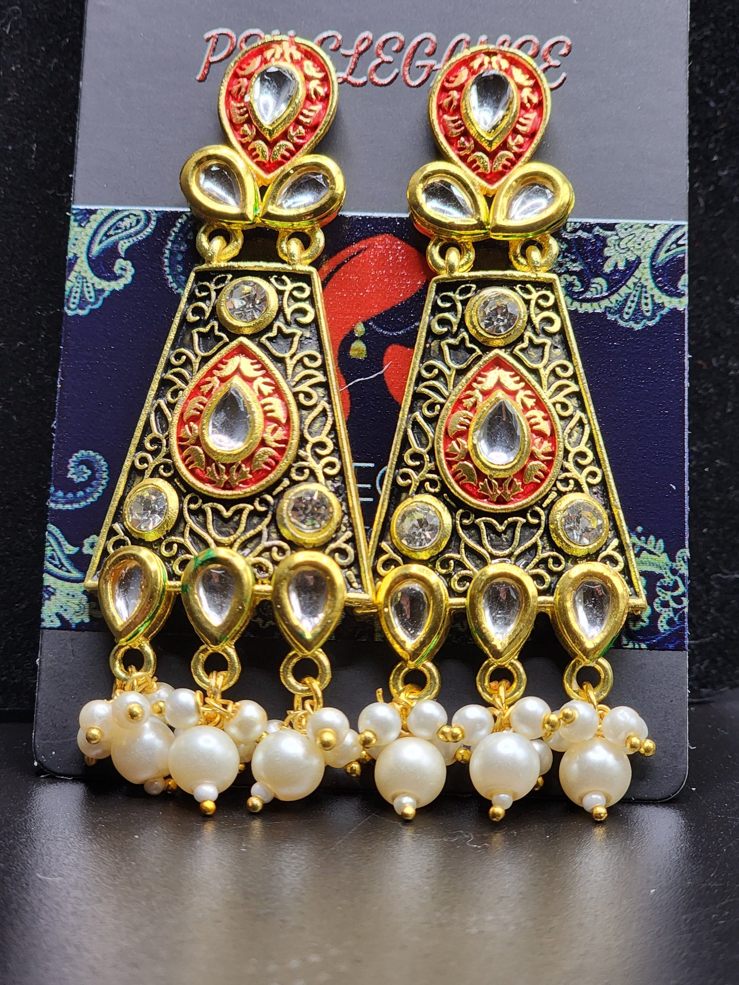 Bold, vibrant, and made to stand out. It's got rich enamel, intricate gold-tone work, and layered bead drops, this piece is desi