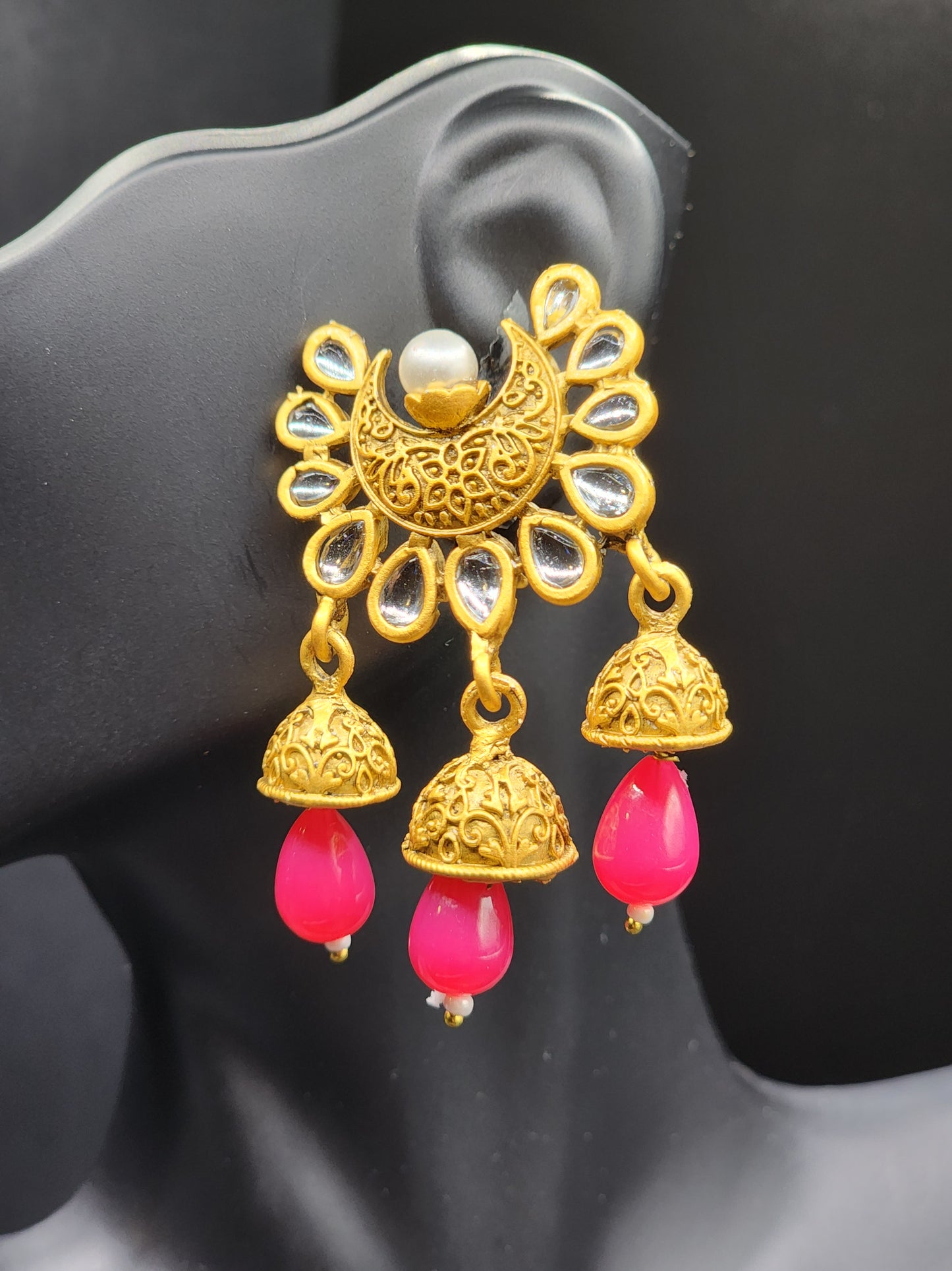 Bold, vibrant, and made to stand out. It's got rich enamel, intricate gold-tone work, and layered bead drops, this piece is desi