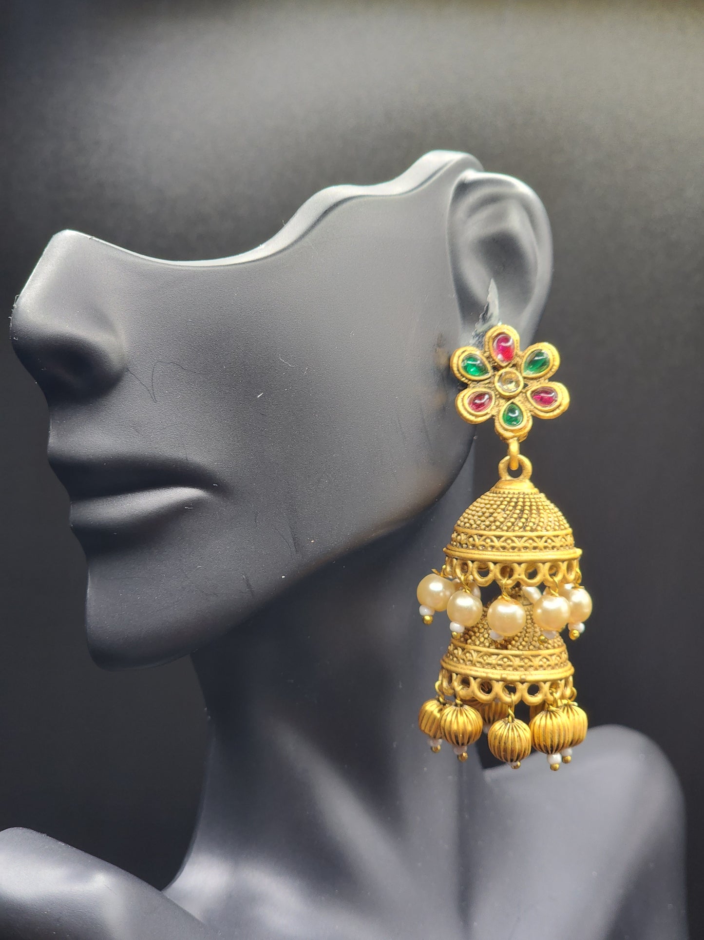 Bold, vibrant, and made to stand out. It's got rich enamel, intricate gold-tone work, and layered bead drops, this piece is desi