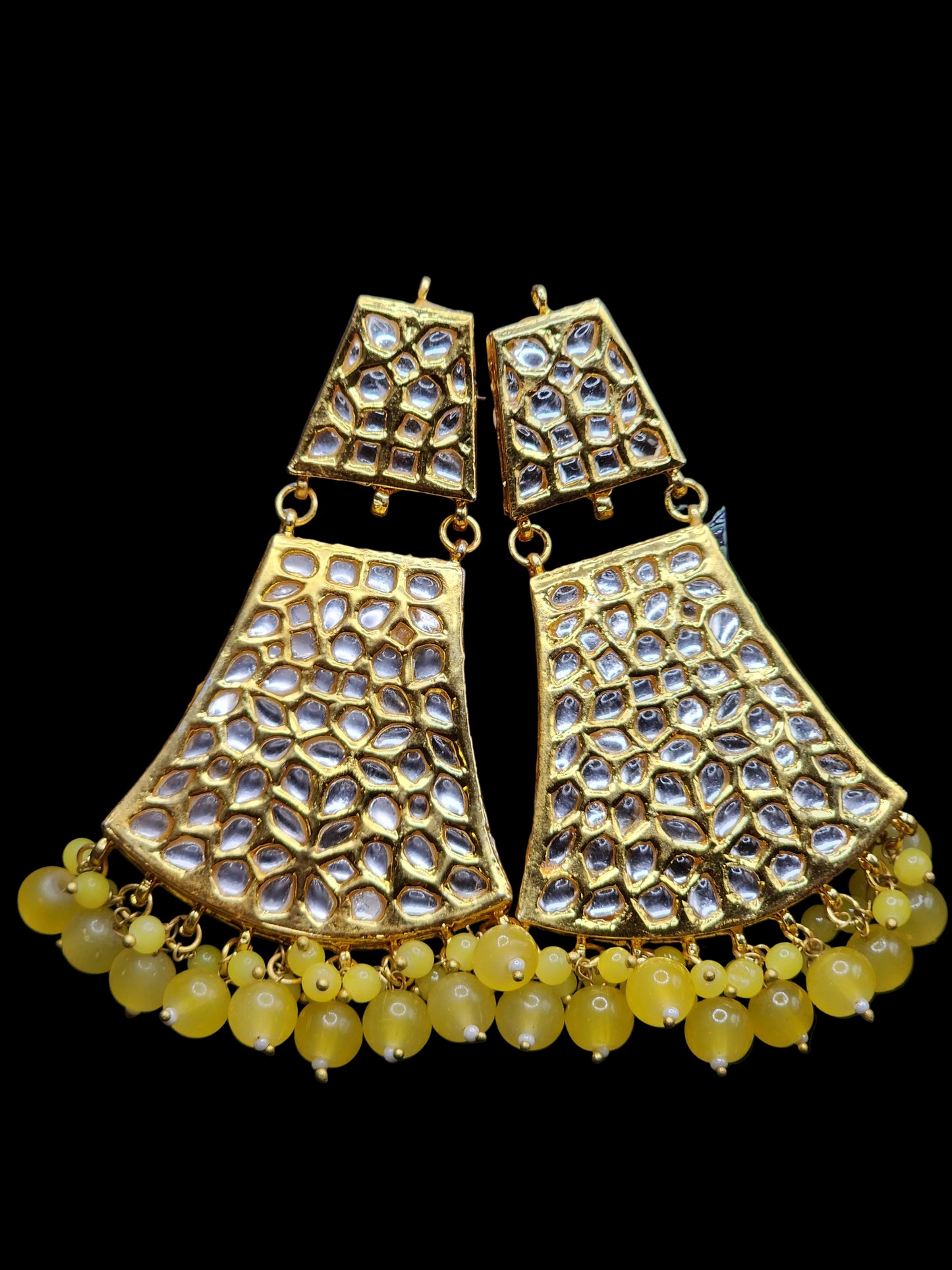 Bold, vibrant, and made to stand out. It's got rich enamel, intricate gold-tone work, and layered bead drops, this piece is desi