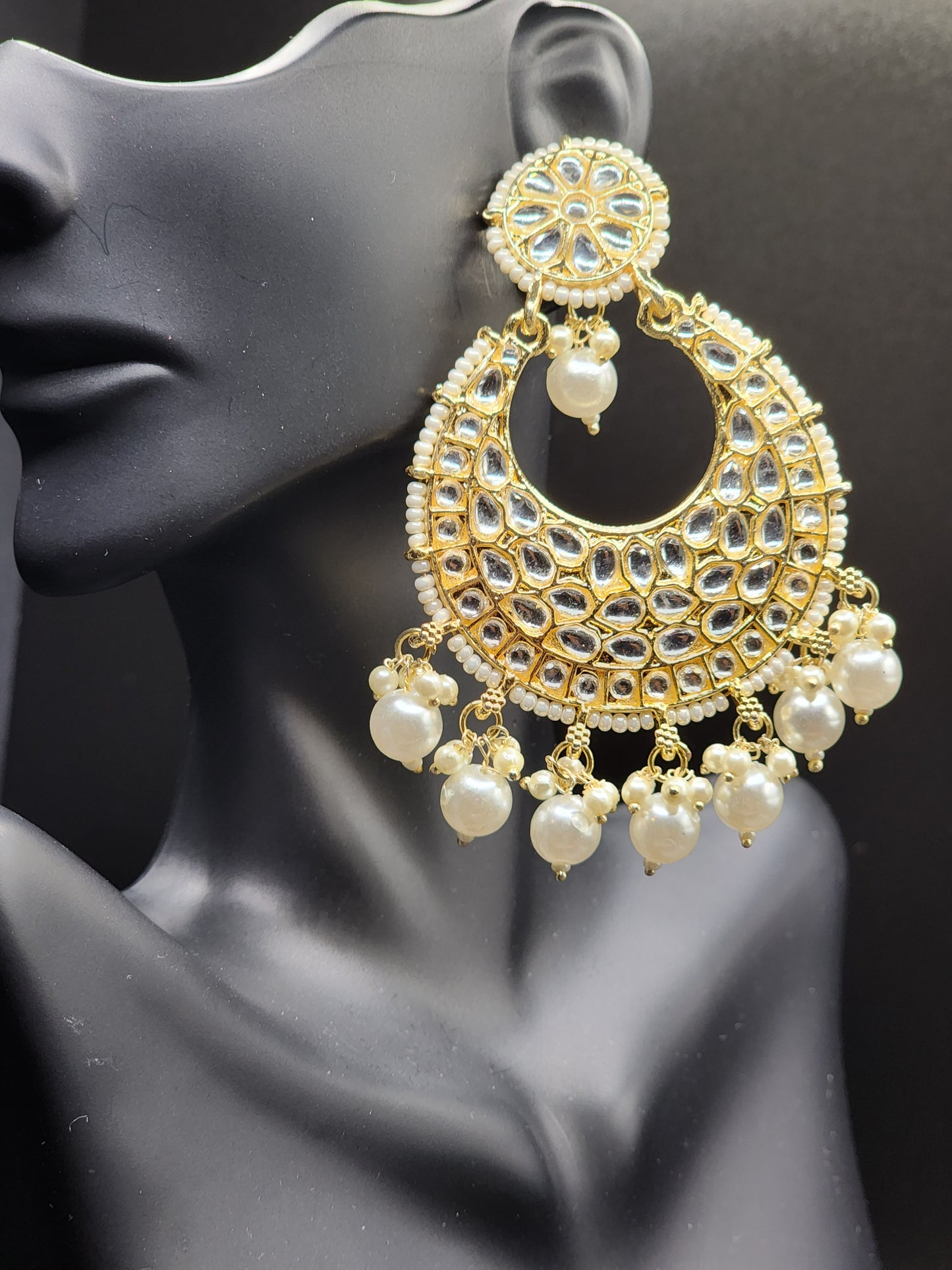 Bold, vibrant, and made to stand out. It's got rich enamel, intricate gold-tone work, and layered bead drops, this piece is desi