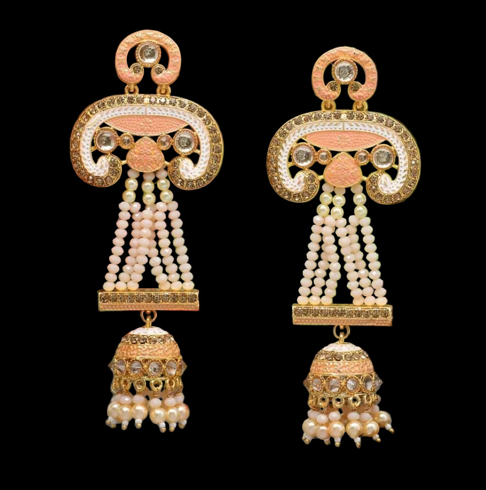Bold, vibrant, and made to stand out. It's got rich enamel, intricate gold-tone work, and layered bead drops, this piece is desi