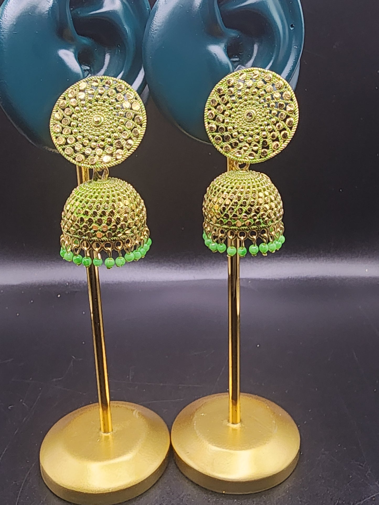 PSK ELEGANCE Gold Jhumka Earrings with Green Bead Detailing