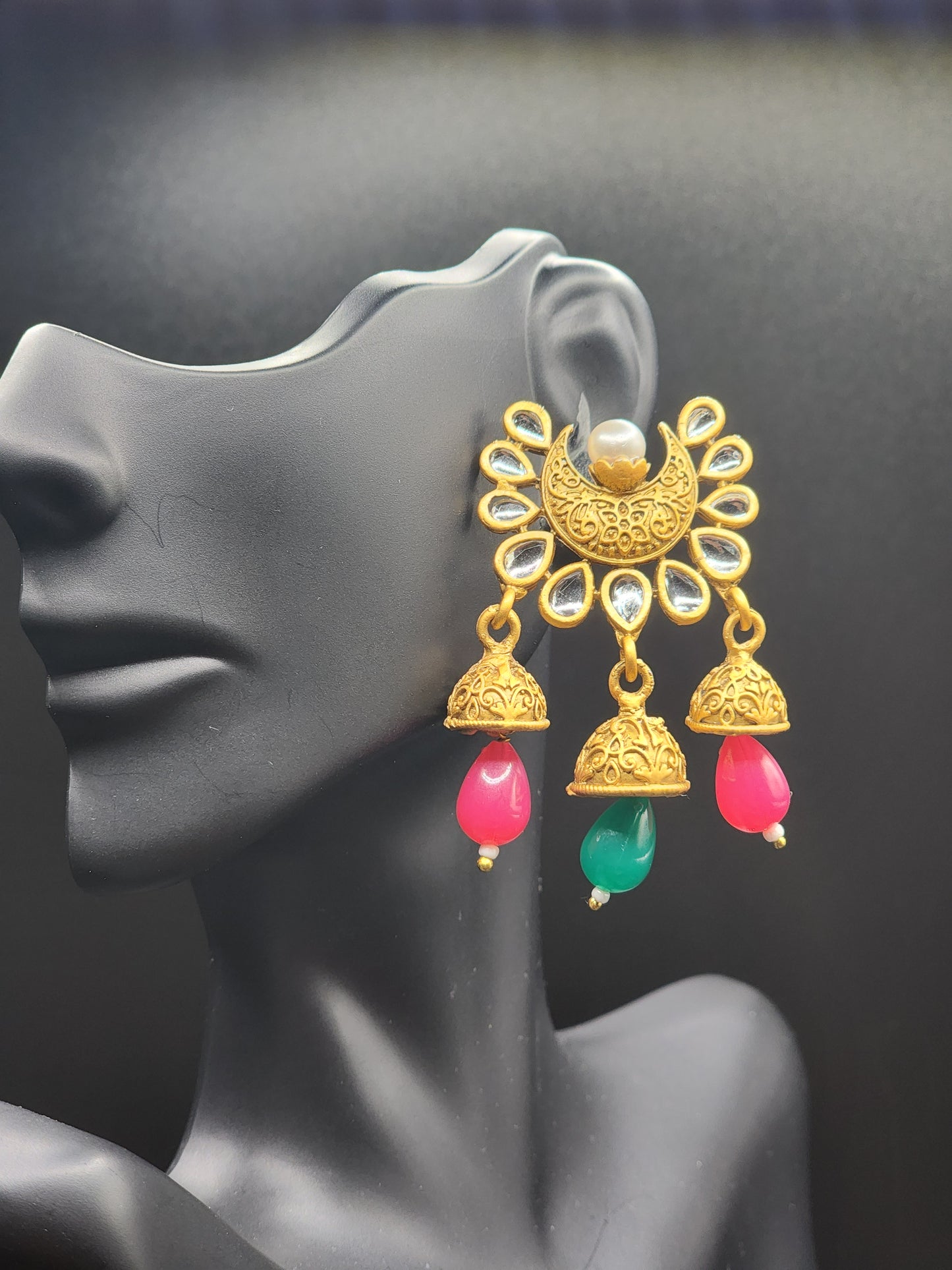 Bold, vibrant, and made to stand out. It's got rich enamel, intricate gold-tone work, and layered bead drops, this piece is desi