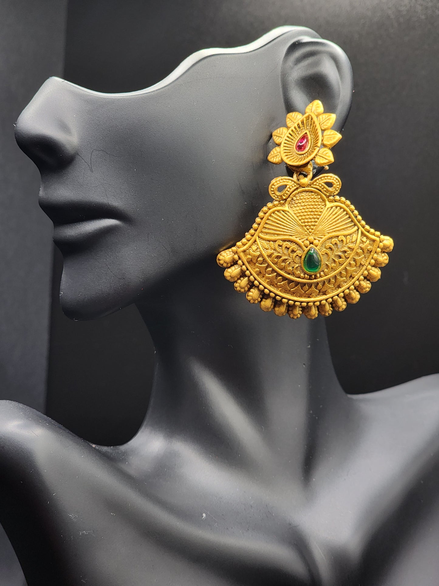 Bold, vibrant, and made to stand out. It's got rich enamel, intricate gold-tone work, and layered bead drops, this piece is desi