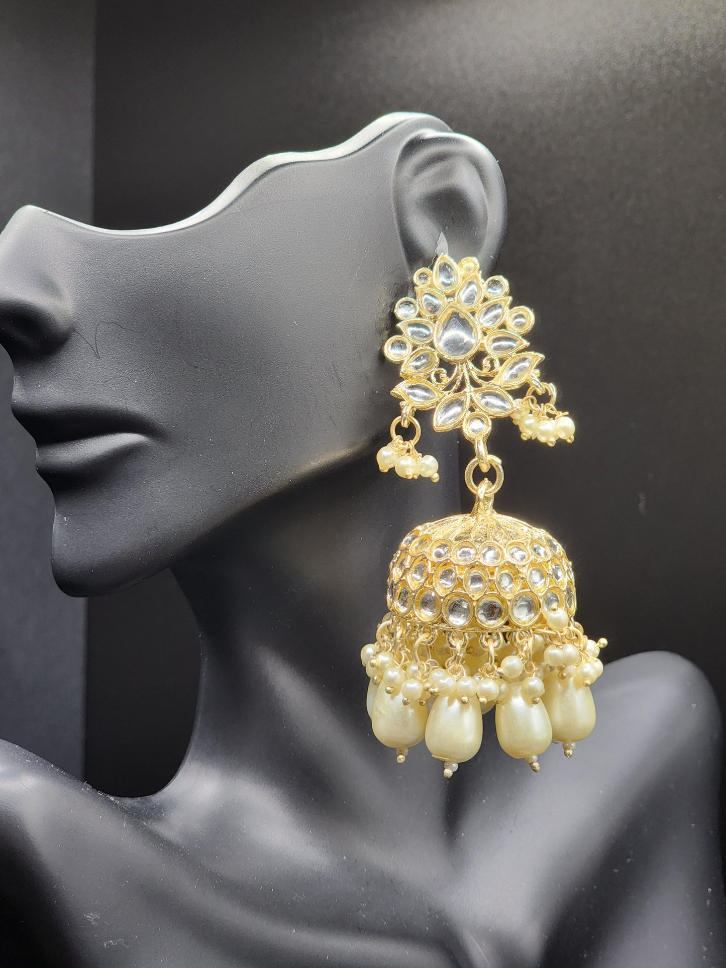 Bold, vibrant, and made to stand out. It's got rich enamel, intricate gold-tone work, and layered bead drops, this piece is desi