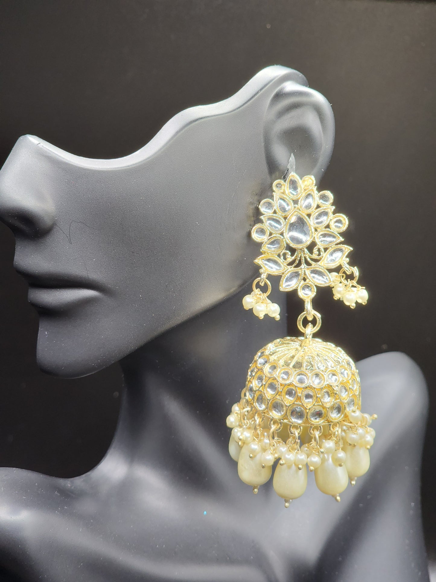 Bold, vibrant, and made to stand out. It's got rich enamel, intricate gold-tone work, and layered bead drops, this piece is desi