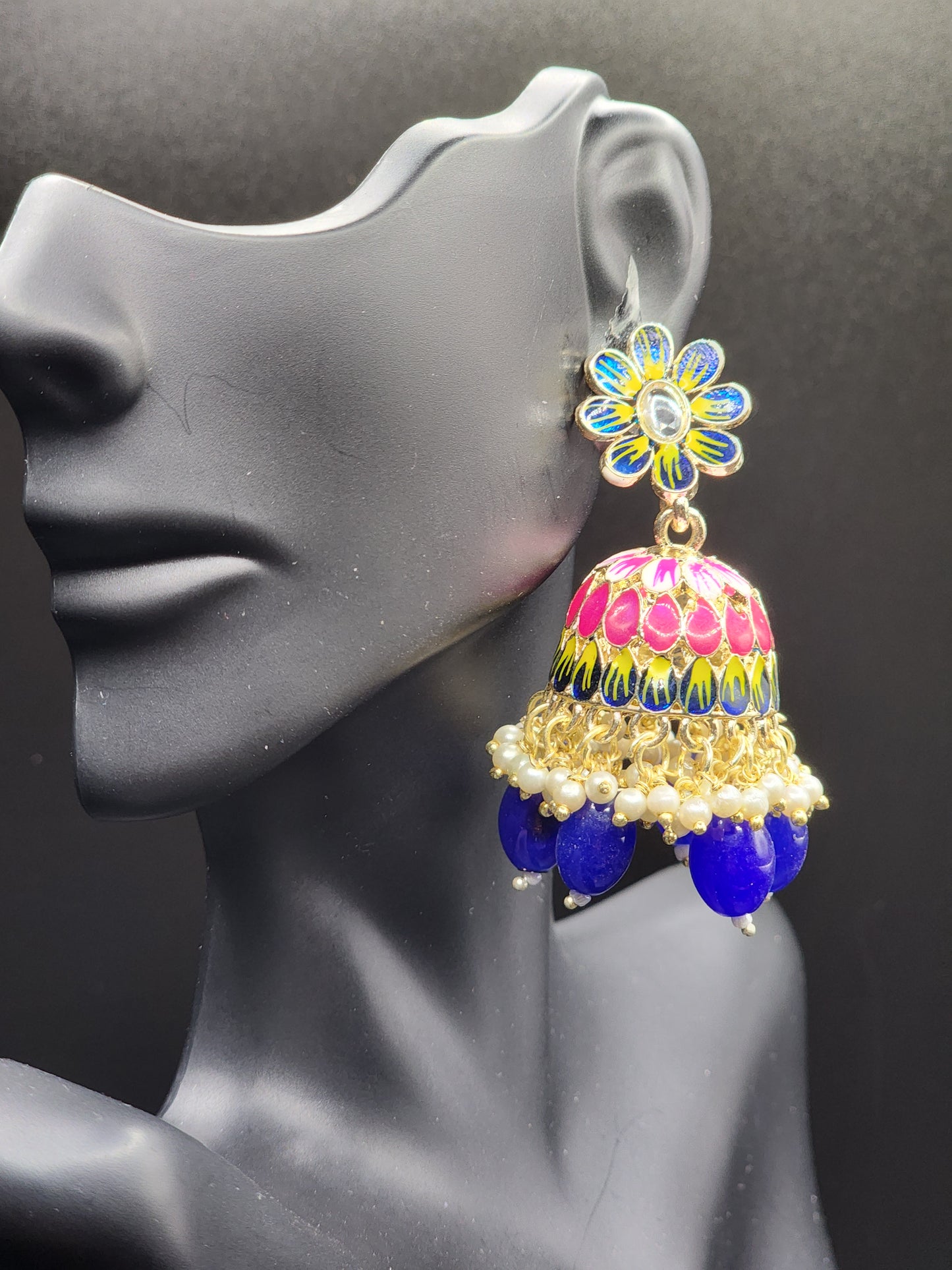Bold, vibrant, and made to stand out. It's got rich enamel, intricate gold-tone work, and layered bead drops, this piece is desi