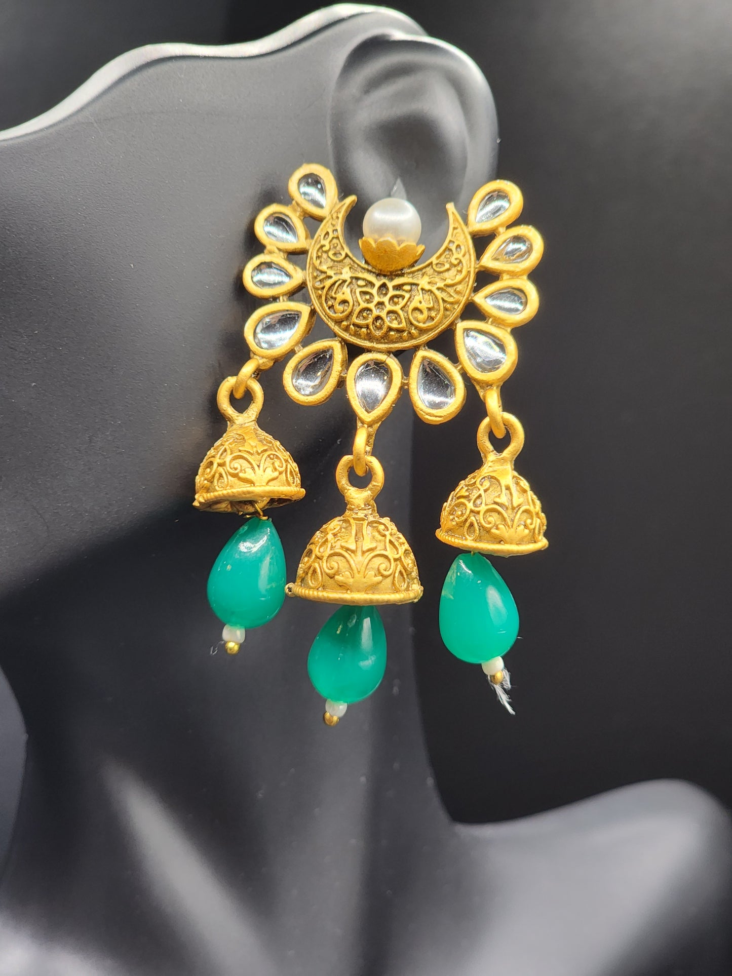 Bold, vibrant, and made to stand out. It's got rich enamel, intricate gold-tone work, and layered bead drops, this piece is desi
