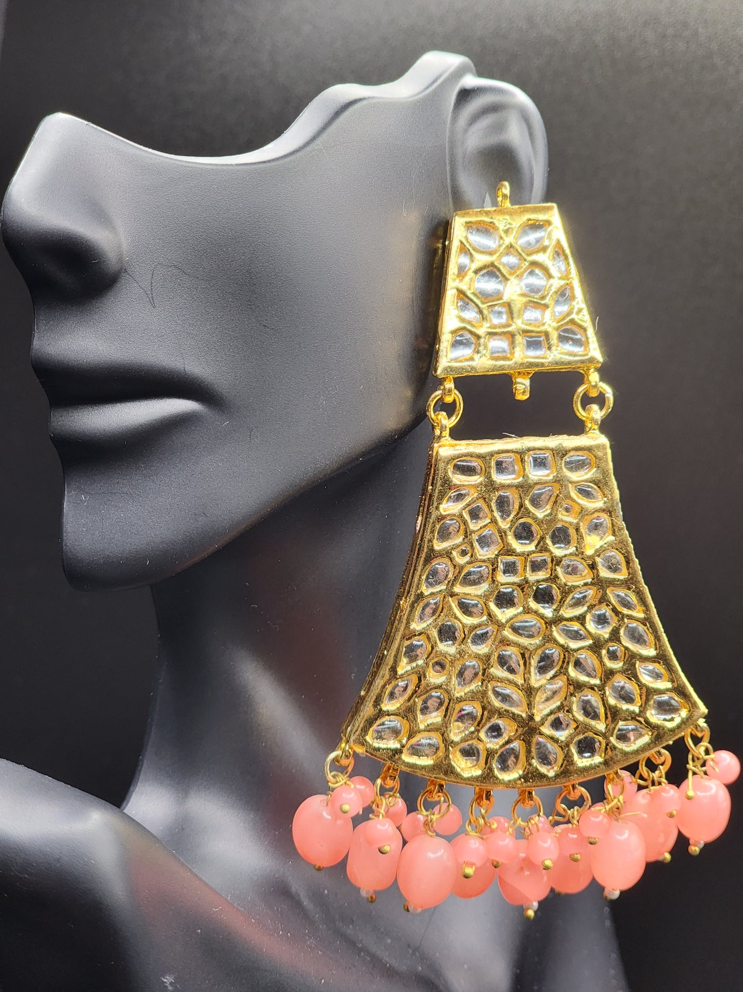 Bold, vibrant, and made to stand out. It's got rich enamel, intricate gold-tone work, and layered bead drops, this piece is desi