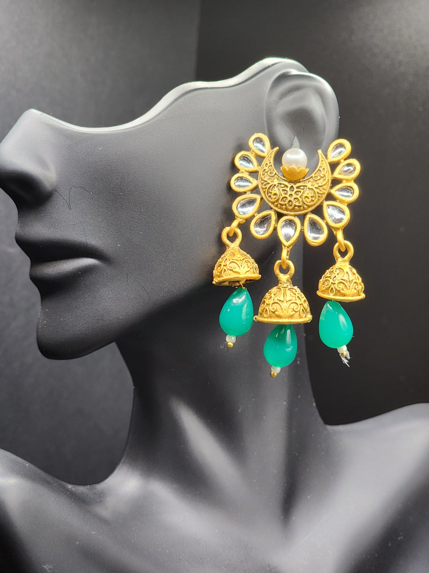Bold, vibrant, and made to stand out. It's got rich enamel, intricate gold-tone work, and layered bead drops, this piece is desi