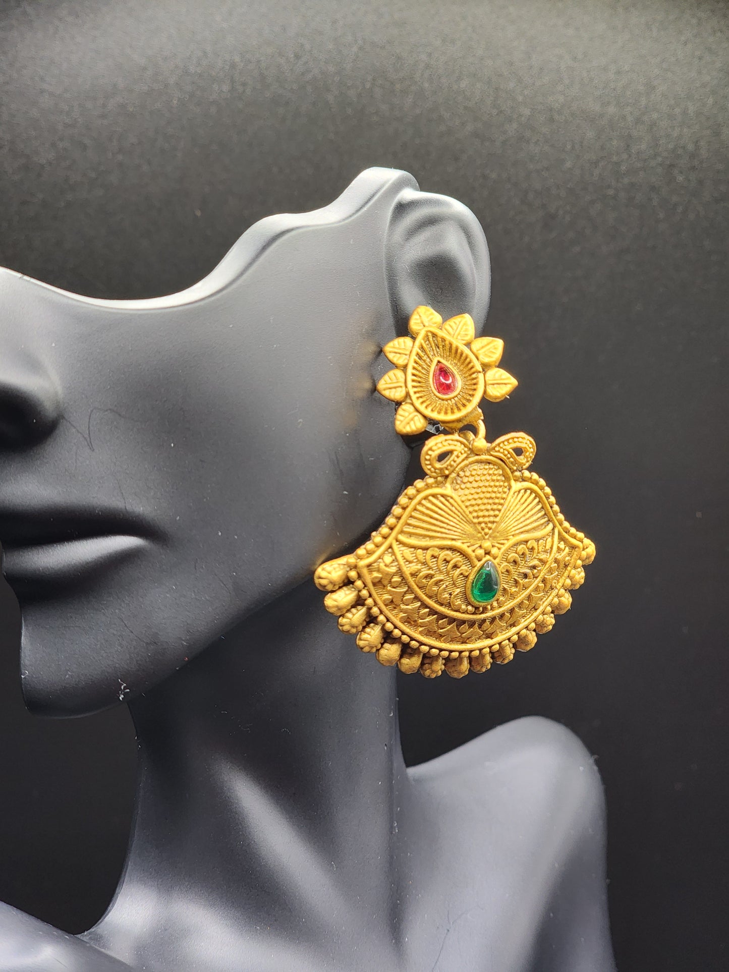 Bold, vibrant, and made to stand out. It's got rich enamel, intricate gold-tone work, and layered bead drops, this piece is desi