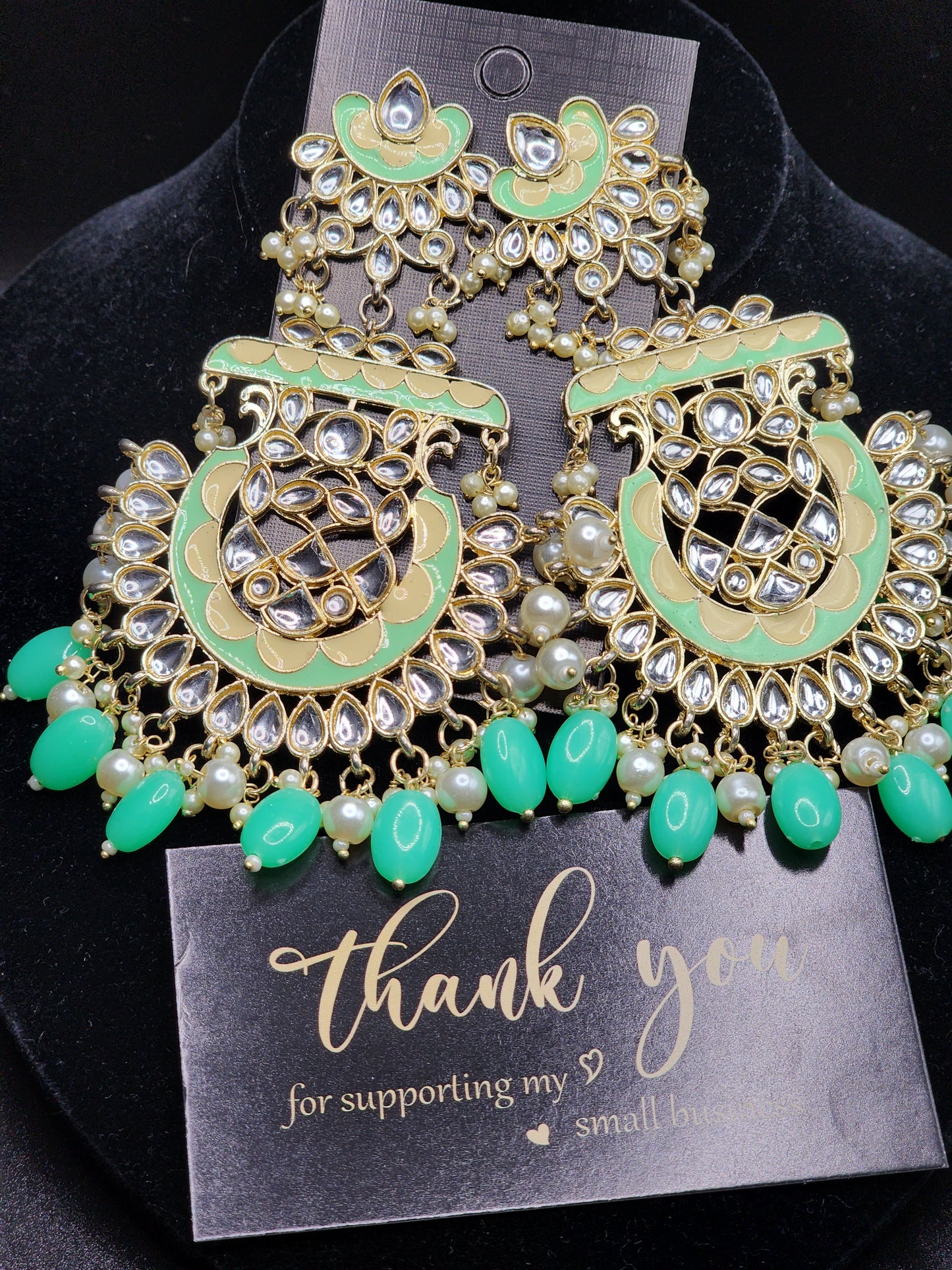 Bold, vibrant, and made to stand out. It's got rich enamel, intricate gold-tone work, and layered bead drops, this piece is desi