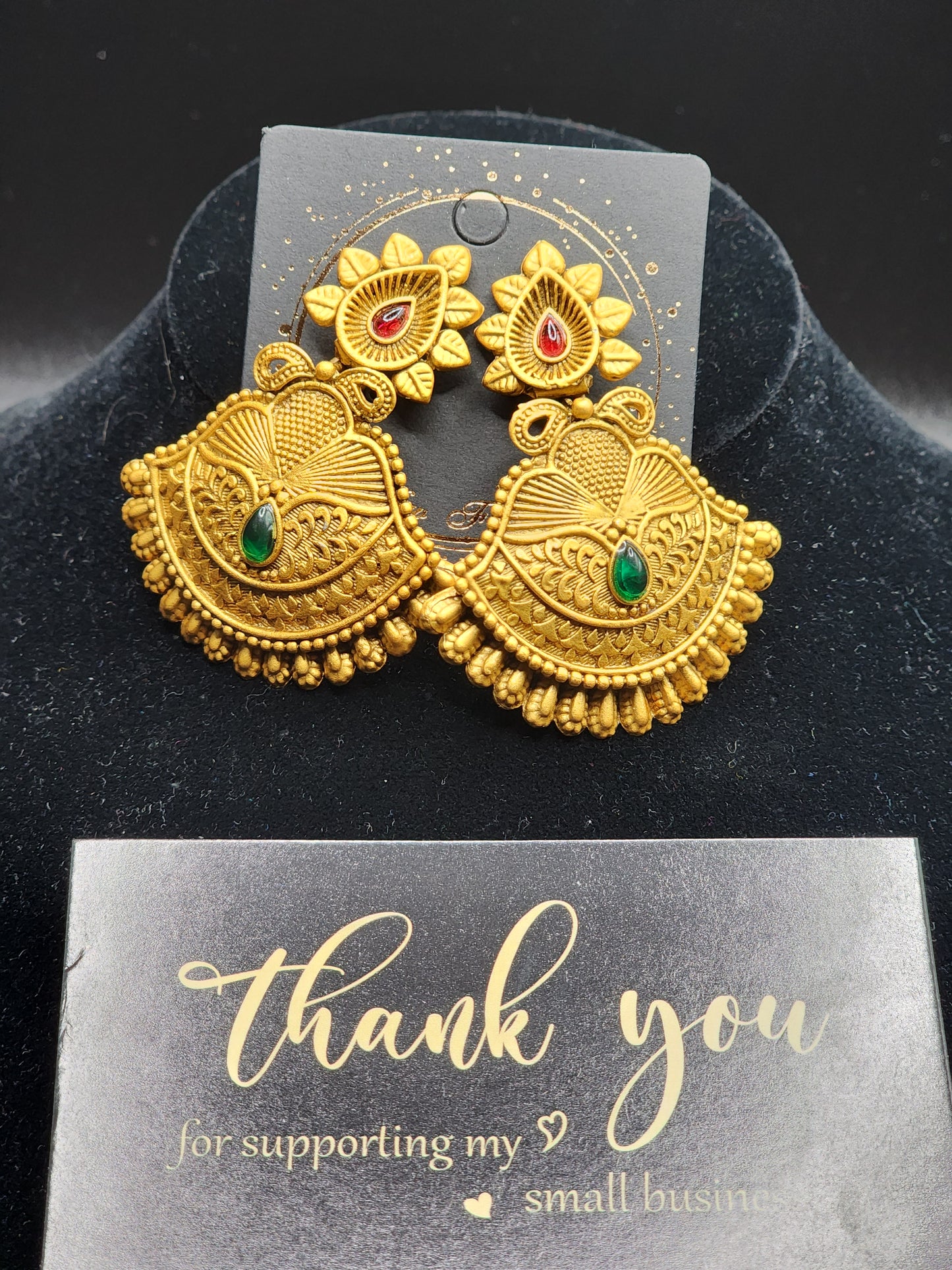 Bold, vibrant, and made to stand out. It's got rich enamel, intricate gold-tone work, and layered bead drops, this piece is desi