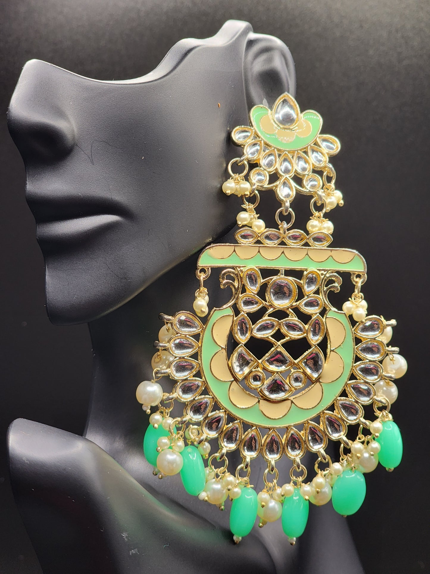 Bold, vibrant, and made to stand out. It's got rich enamel, intricate gold-tone work, and layered bead drops, this piece is desi