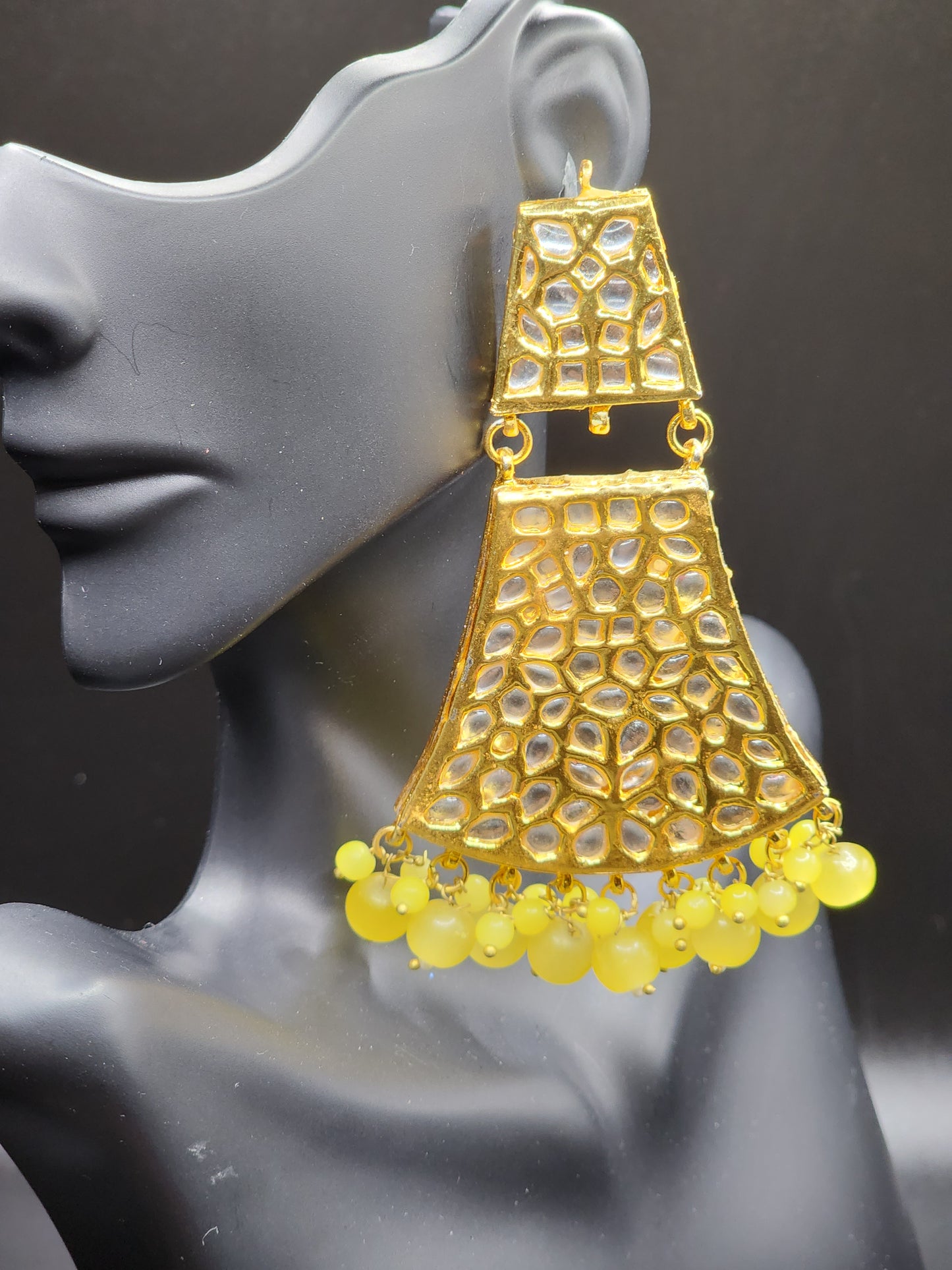 Bold, vibrant, and made to stand out. It's got rich enamel, intricate gold-tone work, and layered bead drops, this piece is desi