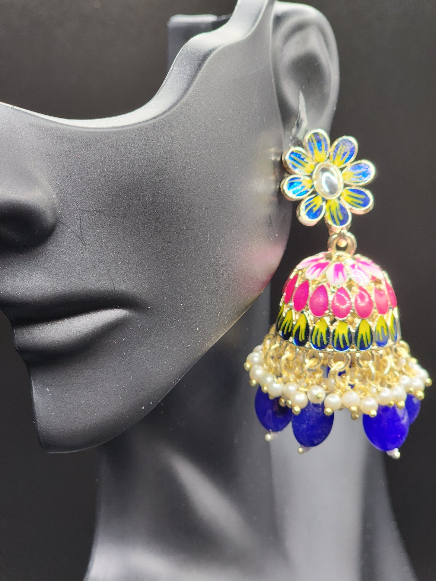 Bold, vibrant, and made to stand out. It's got rich enamel, intricate gold-tone work, and layered bead drops, this piece is desi