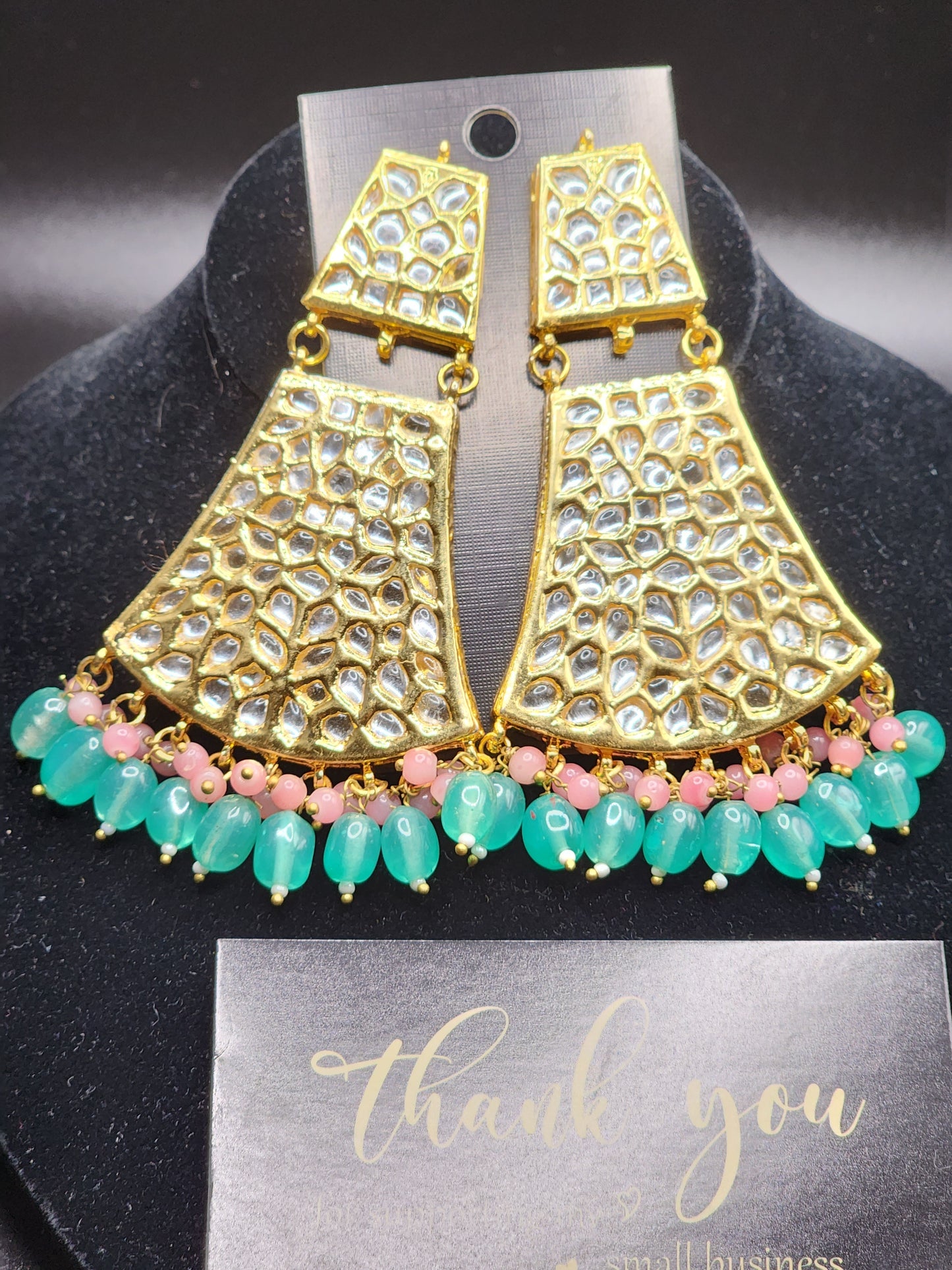 Bold, vibrant, and made to stand out. It's got rich enamel, intricate gold-tone work, and layered bead drops, this piece is desi